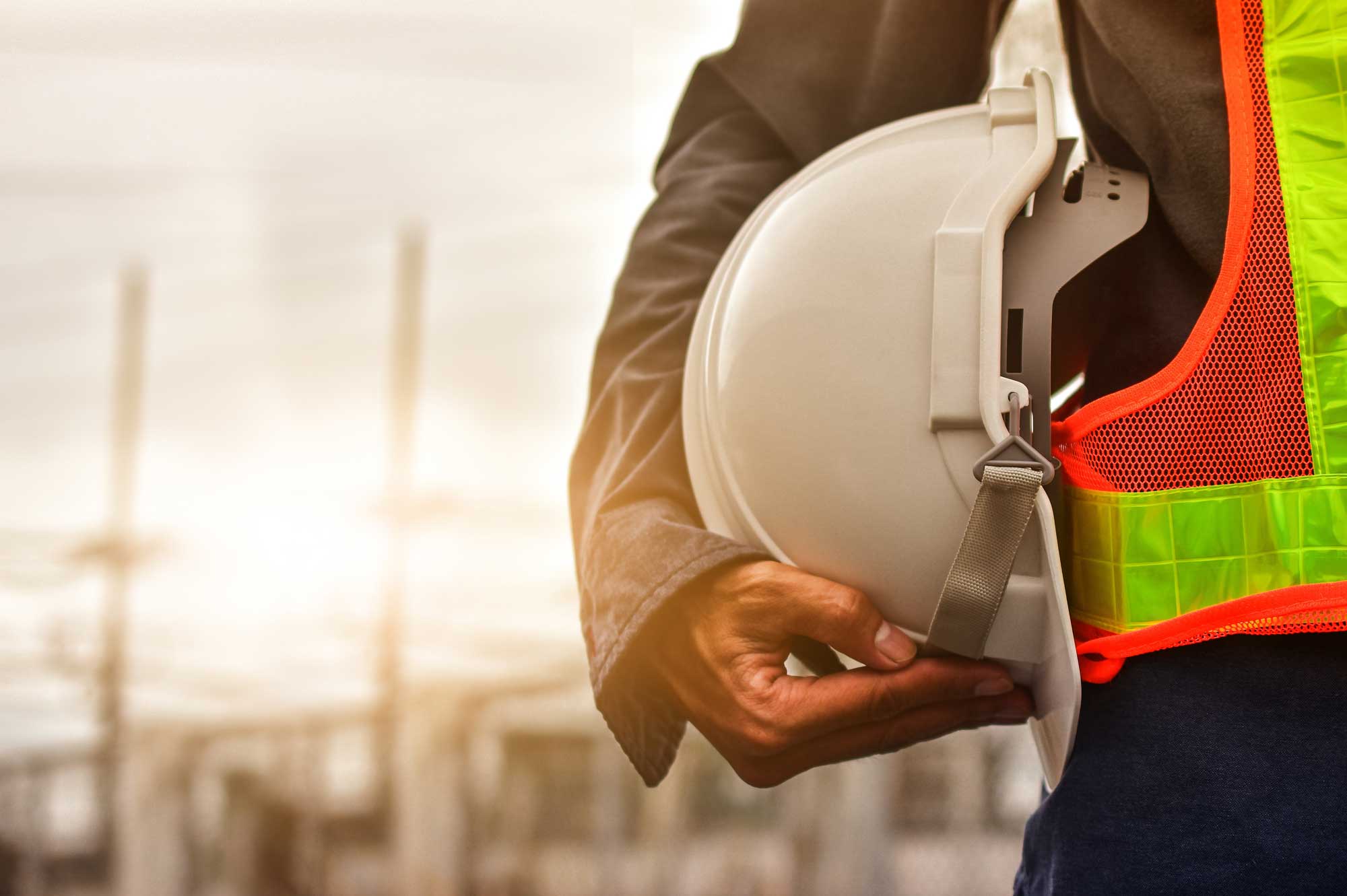 Industrial construction site with workers and safety measures